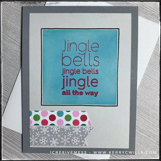 A holiday-inspired handmade card, this dark grey card base is layered with a lighter grey that's been embellished. A turquoise square, centered near the top of the panel has been stenciled in a gorgeous shade of blue. Overlapping it is the sentiment "Jingle bells jingle bells jingle all the way" which has been stamped in red ink and heat embossed with a clear finish. The text is slightly raised off of the card base. There's a beautiful shimmer across the card front and black hand drawn lines nicely outline