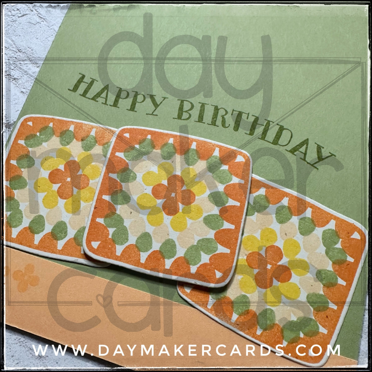 Close up detail of a handmade birthday card featuring die-cut and stamped granny squares and a tone-on-tone sentiment reading "happy birthday". Features Day Maker Cards branding.